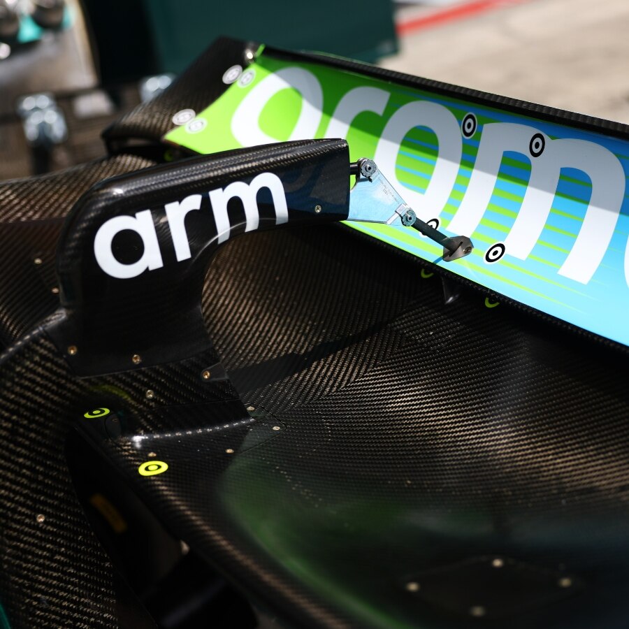 Close-up of Aston Martin F1 car with Arm logo and rear wing assembly