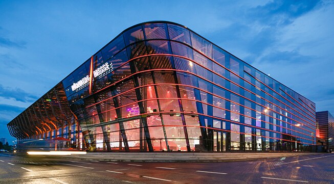 Modern glass building illuminated at night