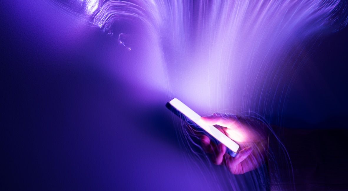 A phone emitting purple light streaks.