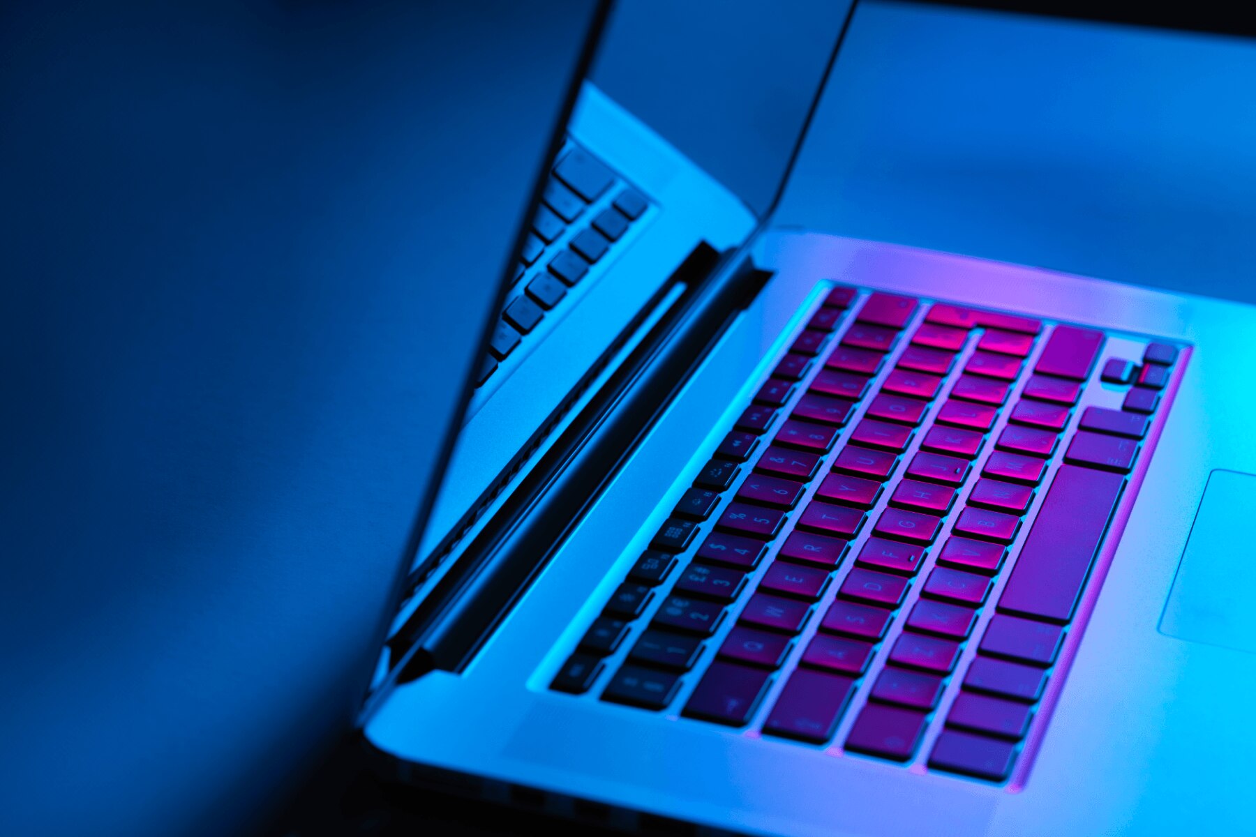 Laptop illuminated by blue and purple light, representing modern Windows application development.