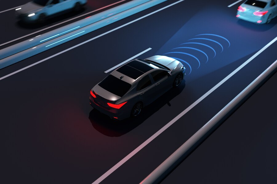 Autonomous vehicle driving on a highway with sensor visualization showing perception and lane detection.