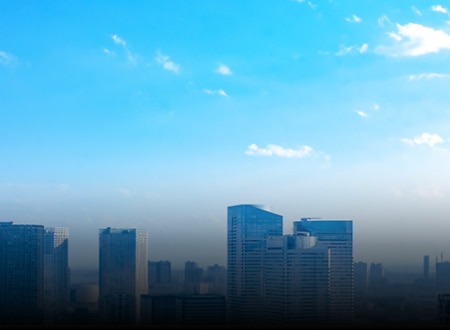 A bright cityscape with clear skies and modern high-rise buildings.