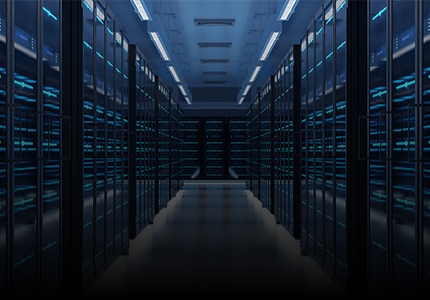 Data center hallway with illuminated server racks.