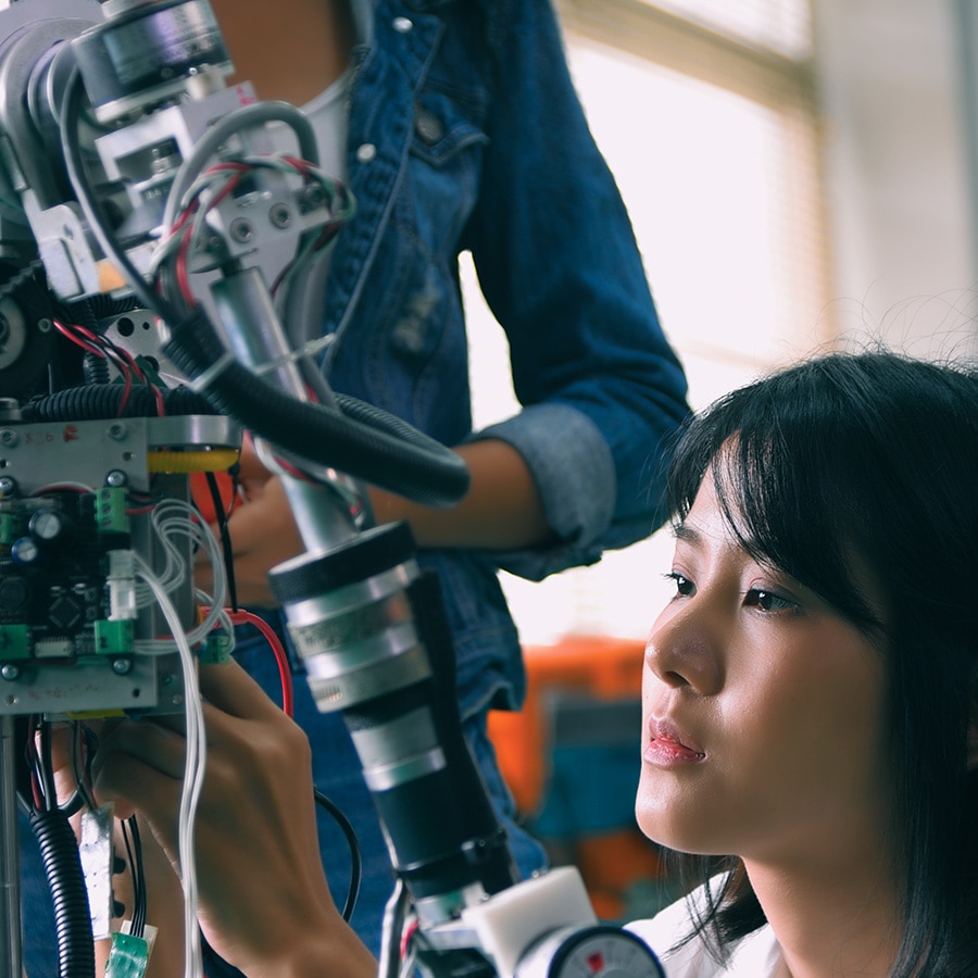 Person wearing a VR headset interacting with a robotic hand.