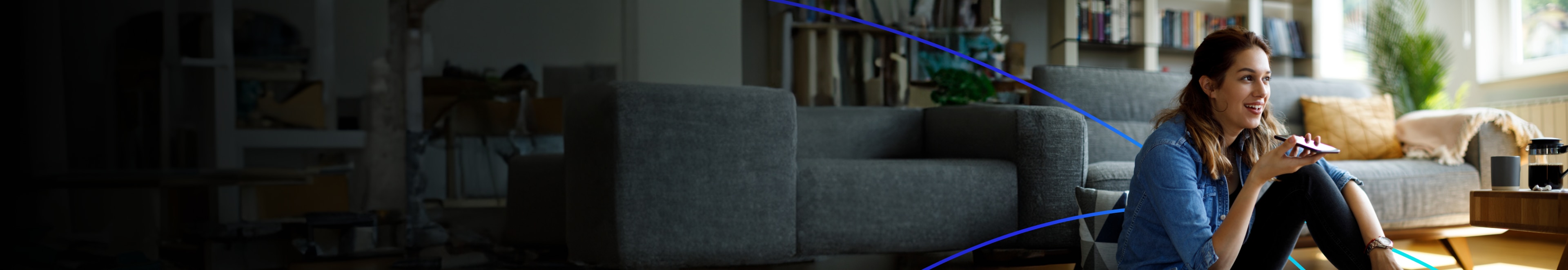 Woman using voice assistant on smartphone at home.