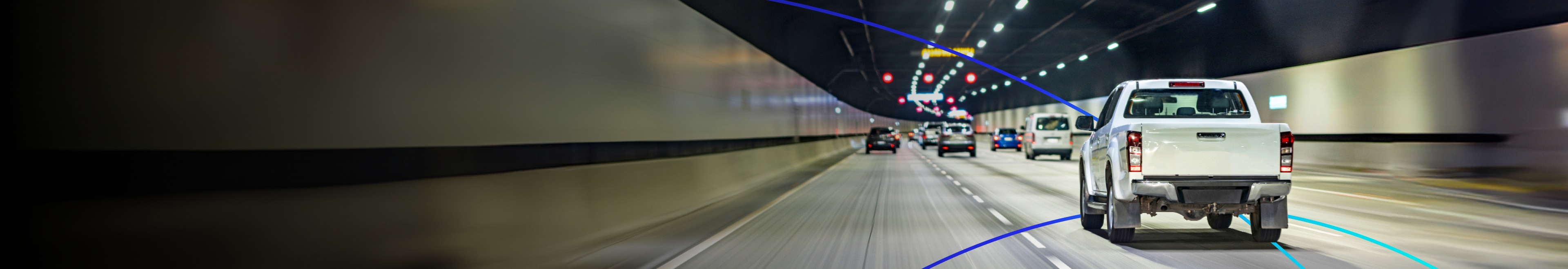 A few fast vehicles are running in the tunnel background