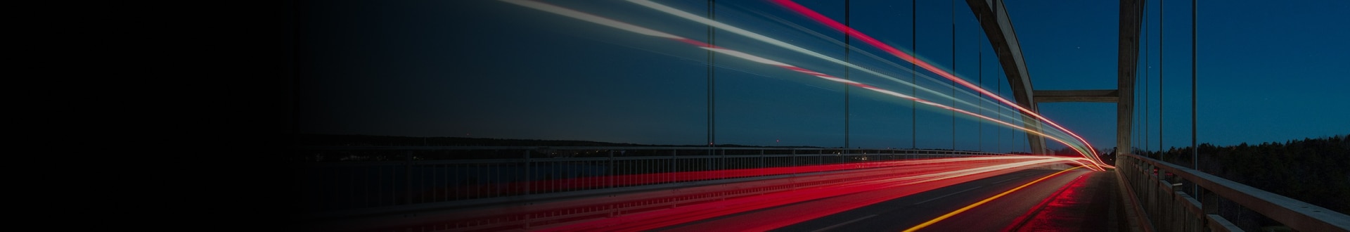 Light trails on a bridge at night