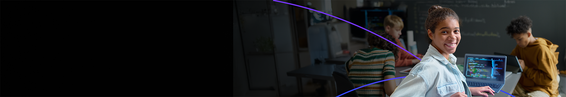 Arm School program new masthead hero banner - A student using a laptop for coding in a classroom, with other students in the background.