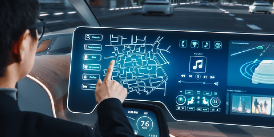 Driver using a vehicle touchscreen interface.