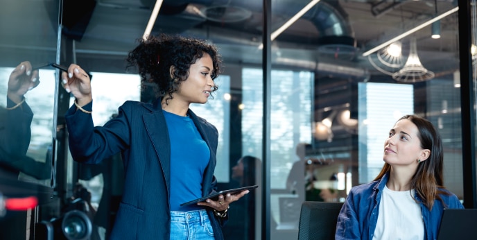 Four people in a modern office meeting room.