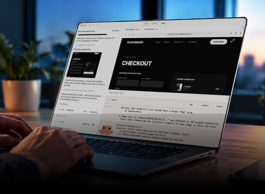 Developer using Claude to build and test a web application on a laptop.